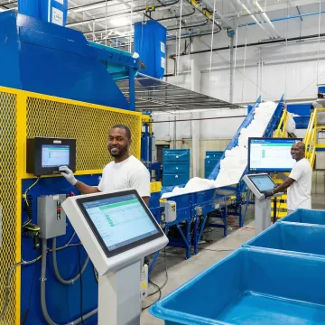 Modern automated industrial laundry facility with conveyor systems and sorting technology