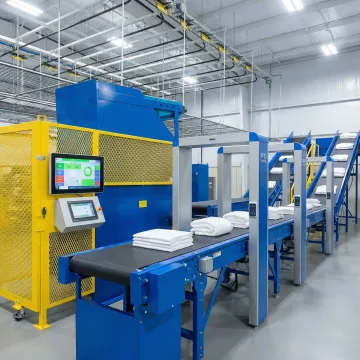 Automated linen distribution system processing hospital linens with RFID technology