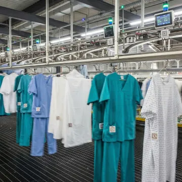 Hospital scrubs on automated RFID tracking conveyor system