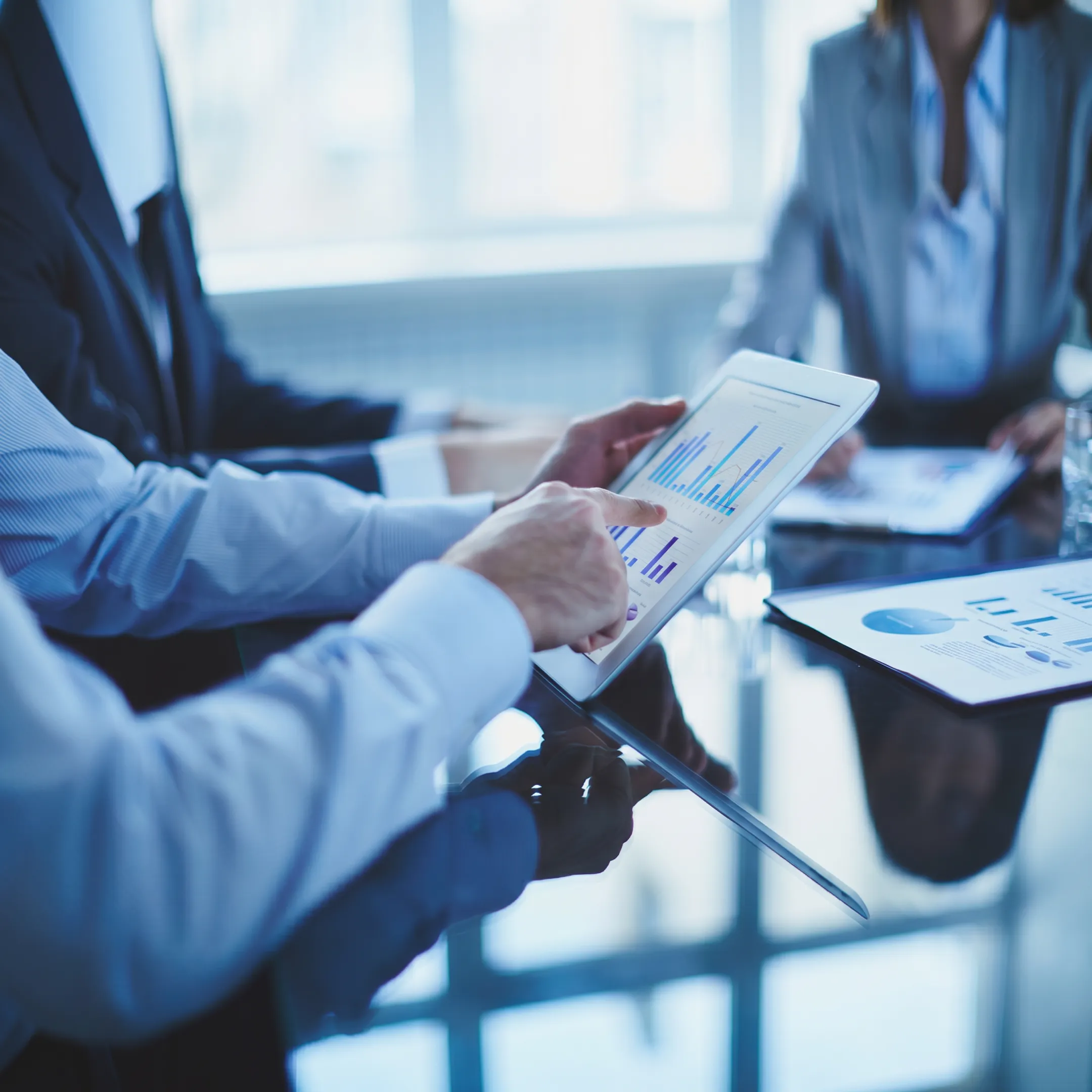 Fractional executive consulting team reviewing growth, finance, technology, and operations strategy in a modern business setting