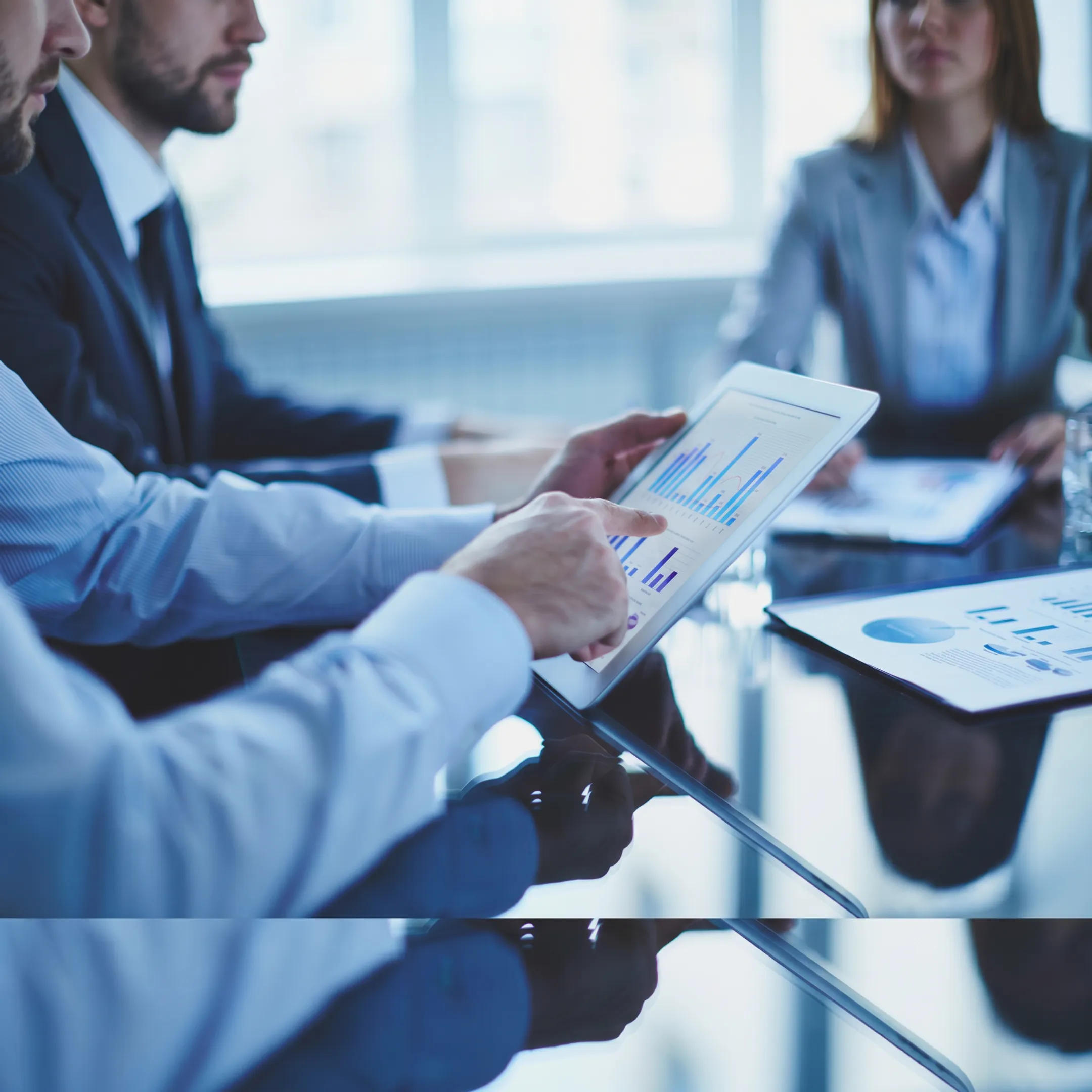 Fractional CFO reviewing startup financial dashboards with founders in a modern office