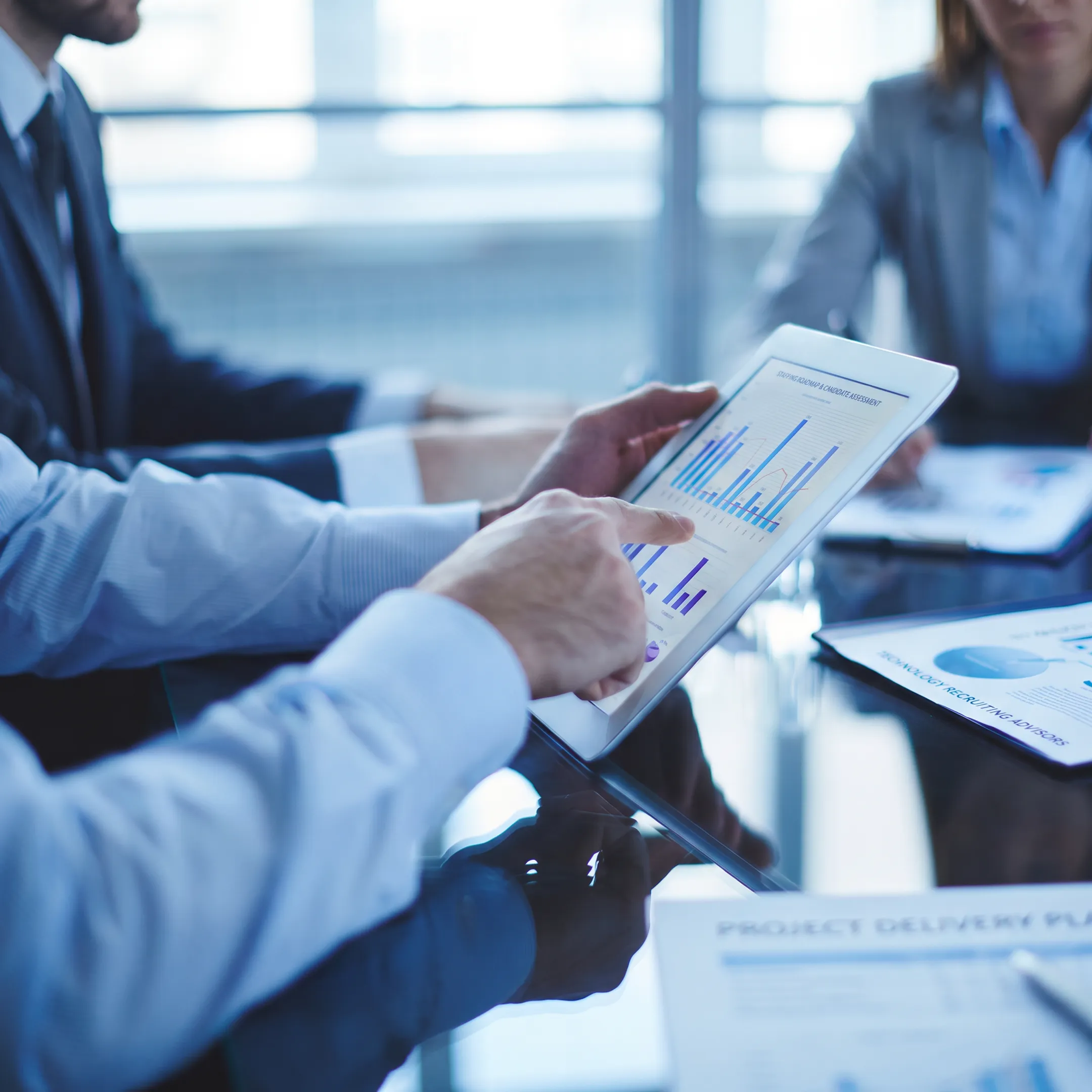 Recruiting consultants reviewing a technology staffing plan with a client