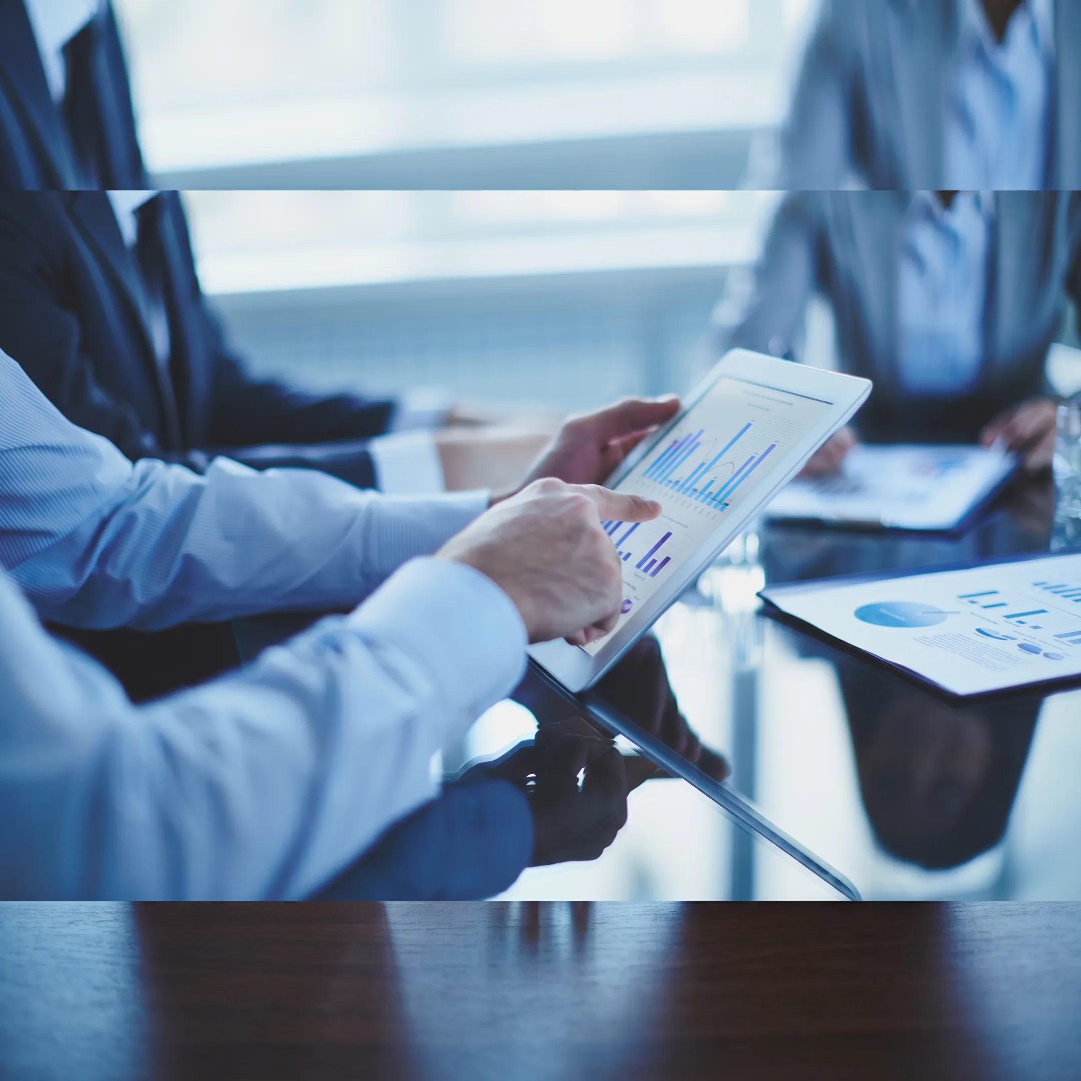 Virtual CFO reviewing business financial reports with leadership team