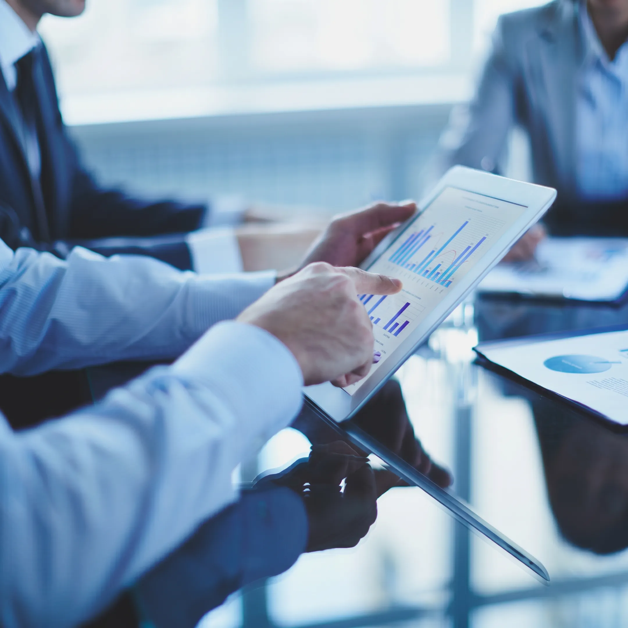 Interim CFO reviewing financial reports with business leadership