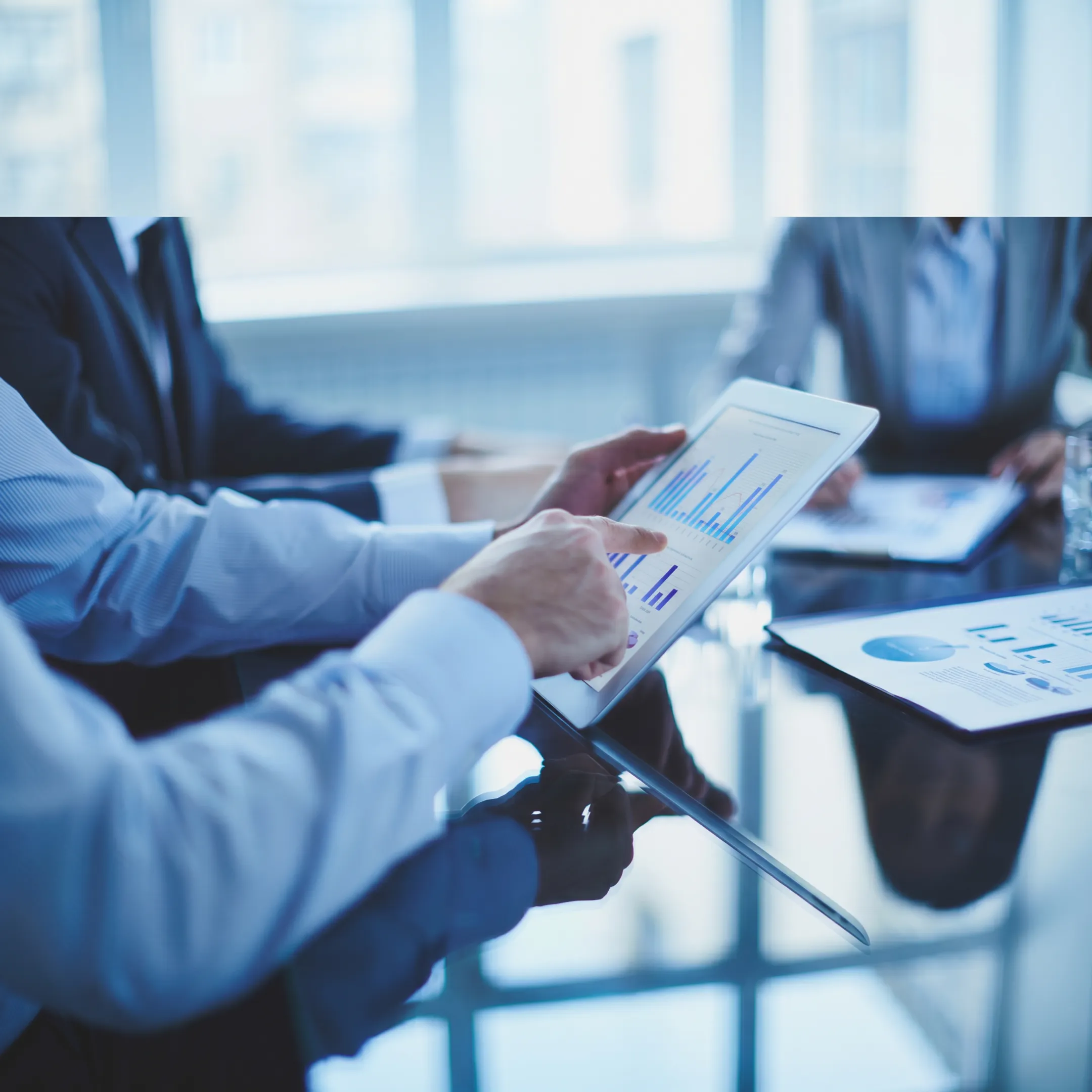 AI consultants collaborating with business leaders around a digital strategy dashboard