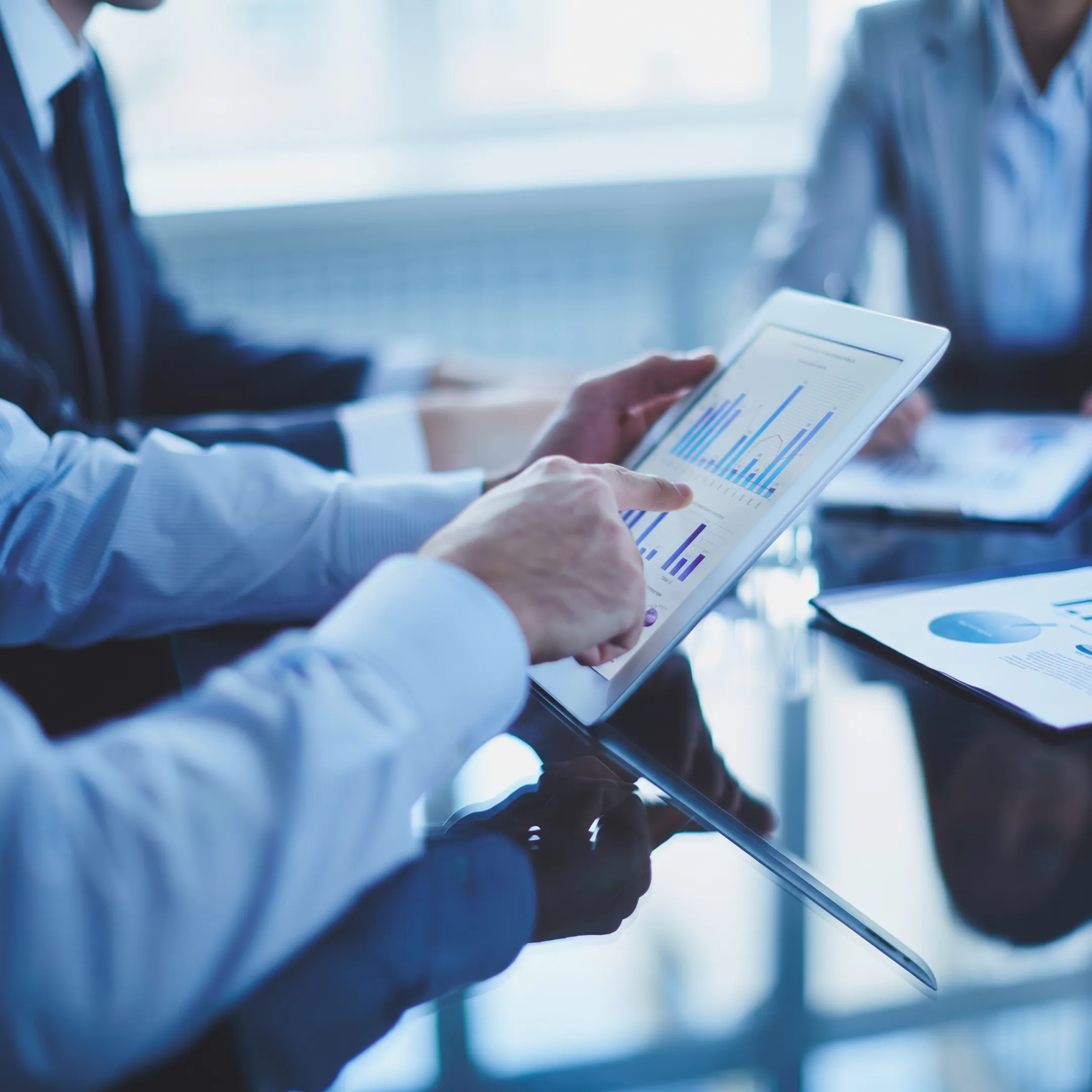 Cybersecurity staffing team reviewing security dashboards during a business meeting