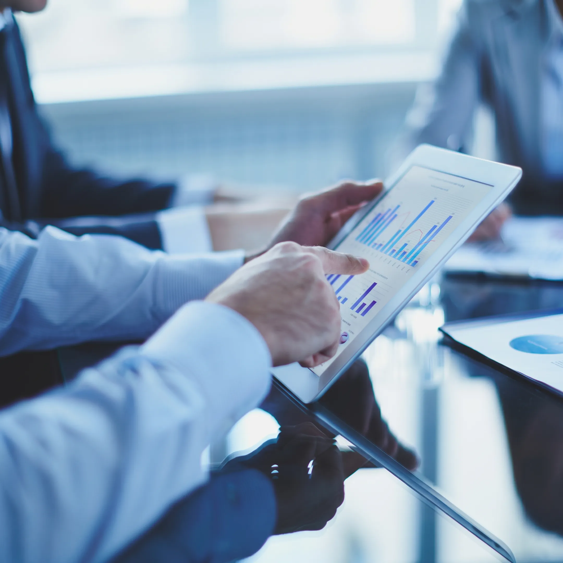 Fractional CFO reviewing financial reports with a business leadership team