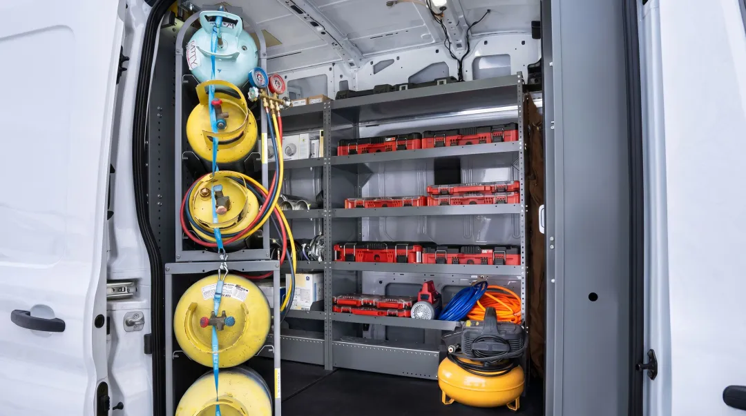 Field service technician organized truck inventory with parts and equipment for dispatch