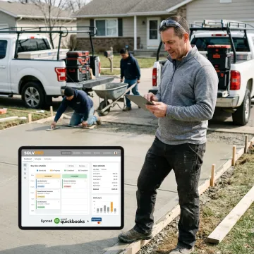 Driveway contractor using CRM software on a tablet