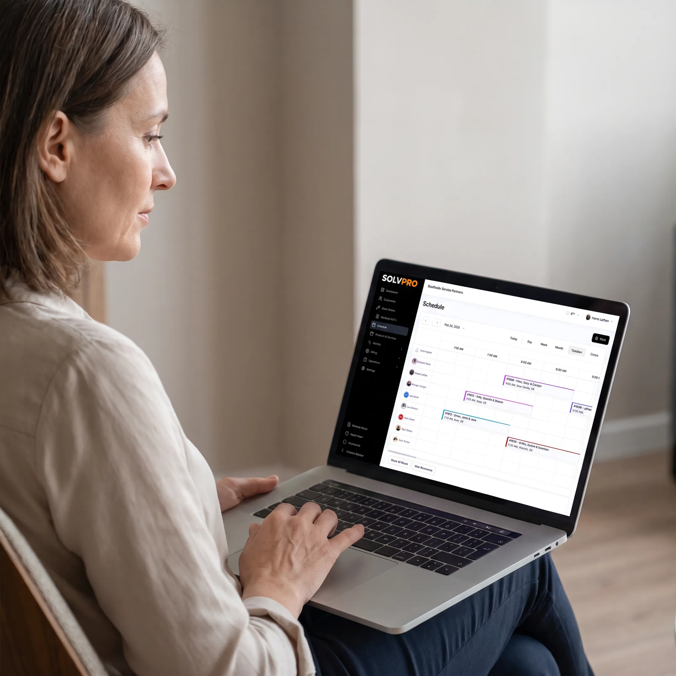 Service business manager reviewing client and job information on software