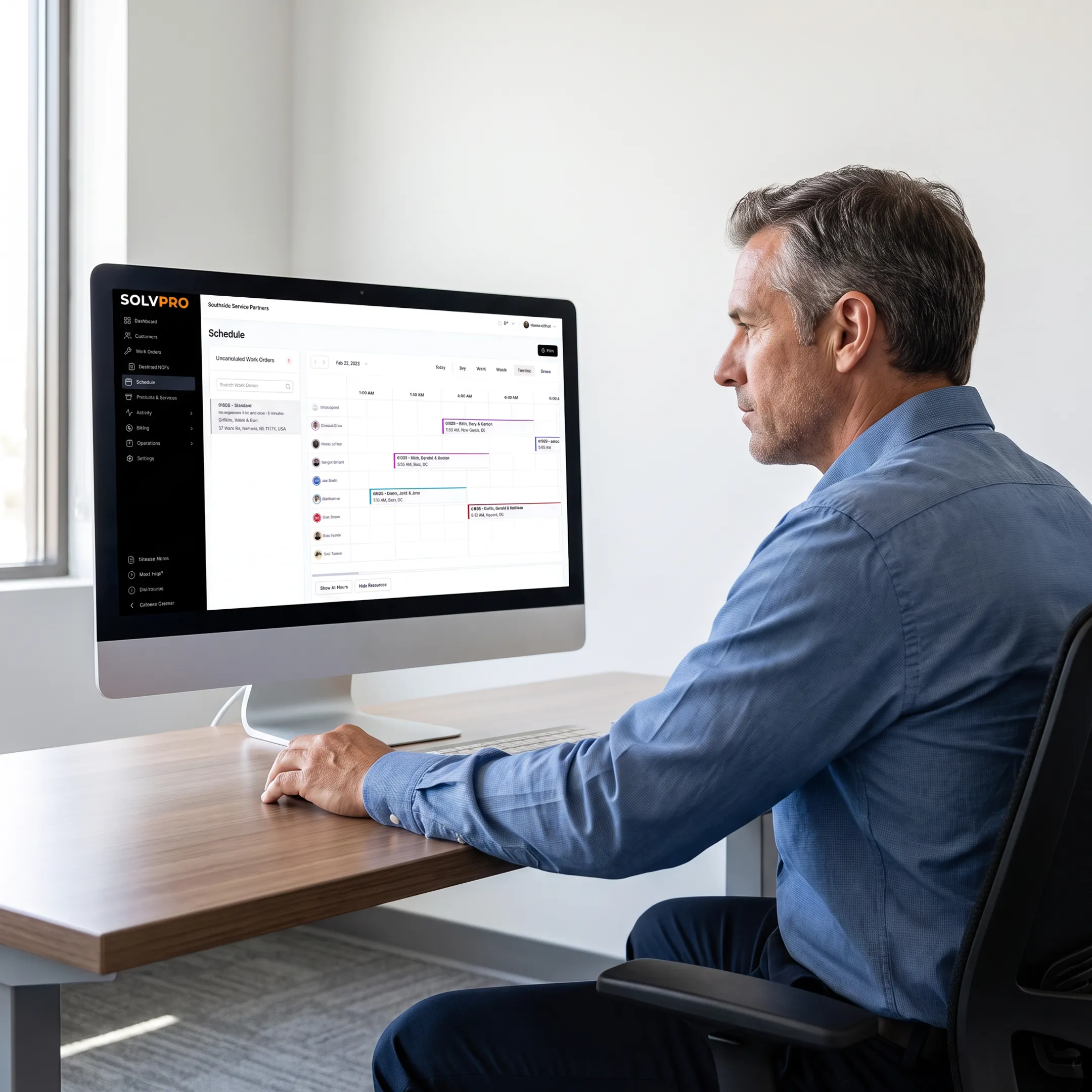 Field service manager reviewing an intelligent scheduling calendar with crew assignments