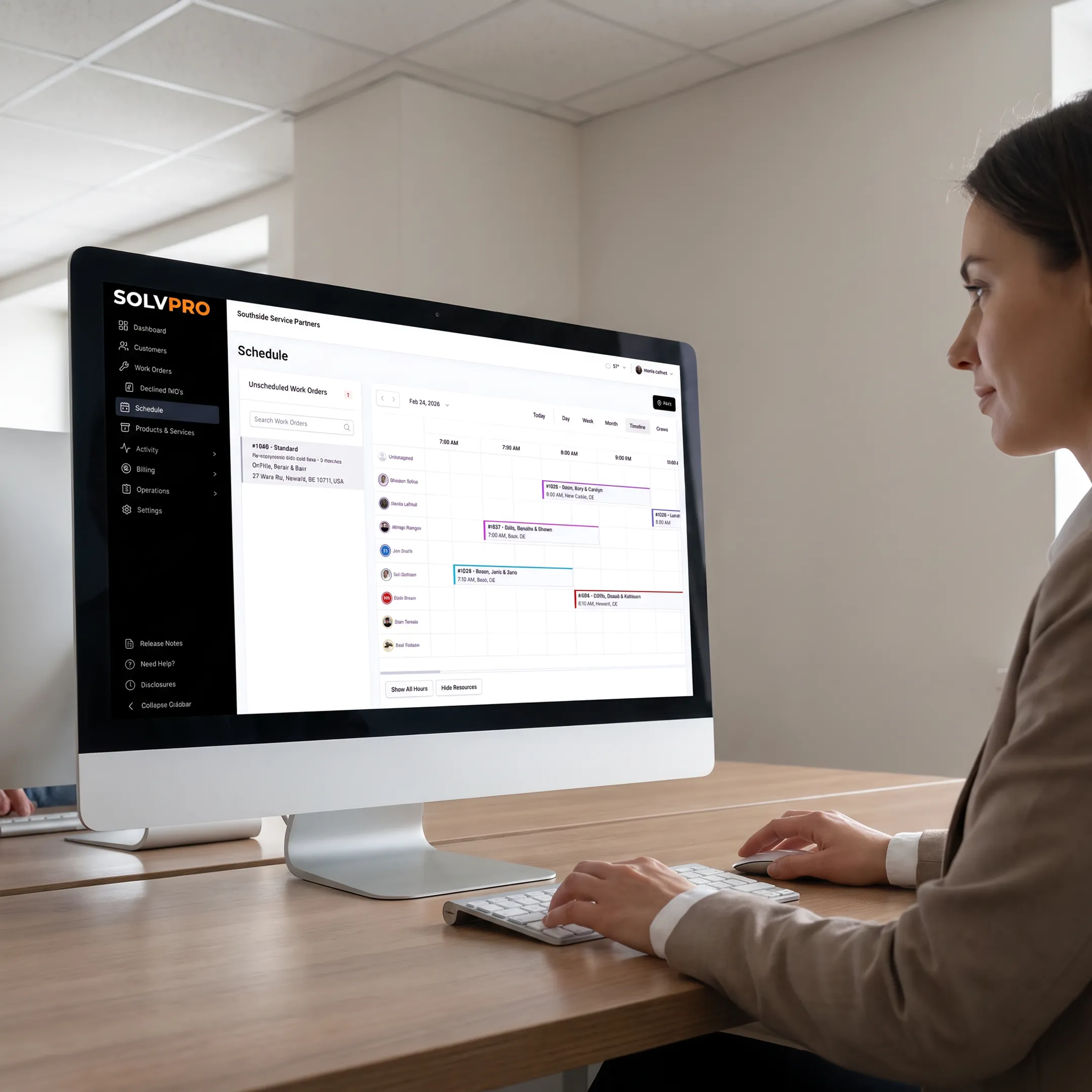 Office coordinator managing field jobs on software dashboard