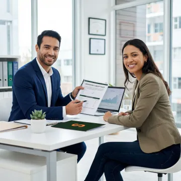 Insurance broker reviewing a general liability policy document with a septic tank contractor.