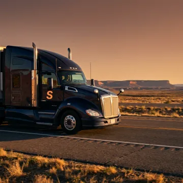 Owner-operator semi-truck on an open highway, representing commercial trucking insurance.