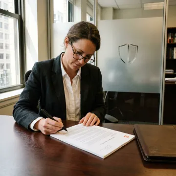 A lawyer reviewing legal documents in a modern Washington D.C. office.