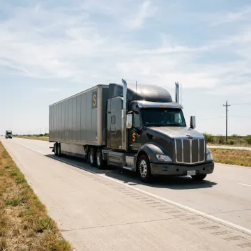 A commercial semi-truck driving on a highway in Texas City, TX.