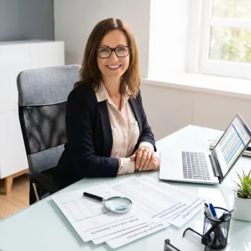 Bookkeeper reviewing tax documents and financial statements