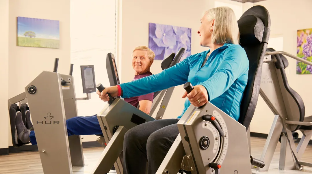 Senior living wellness space with accessible fitness equipment and therapeutic memory care environment