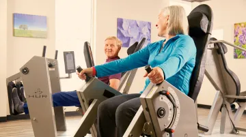 Senior living wellness space with accessible fitness equipment and therapeutic memory care environment