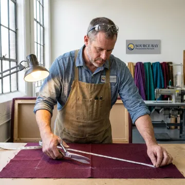 Commercial upholsterer restoring restaurant booth