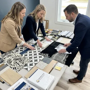 Design team reviewing multi-family furnishing samples