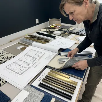 Designer reviewing hotel drapery hardware samples