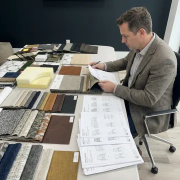 Procurement specialist reviewing commercial furniture samples
