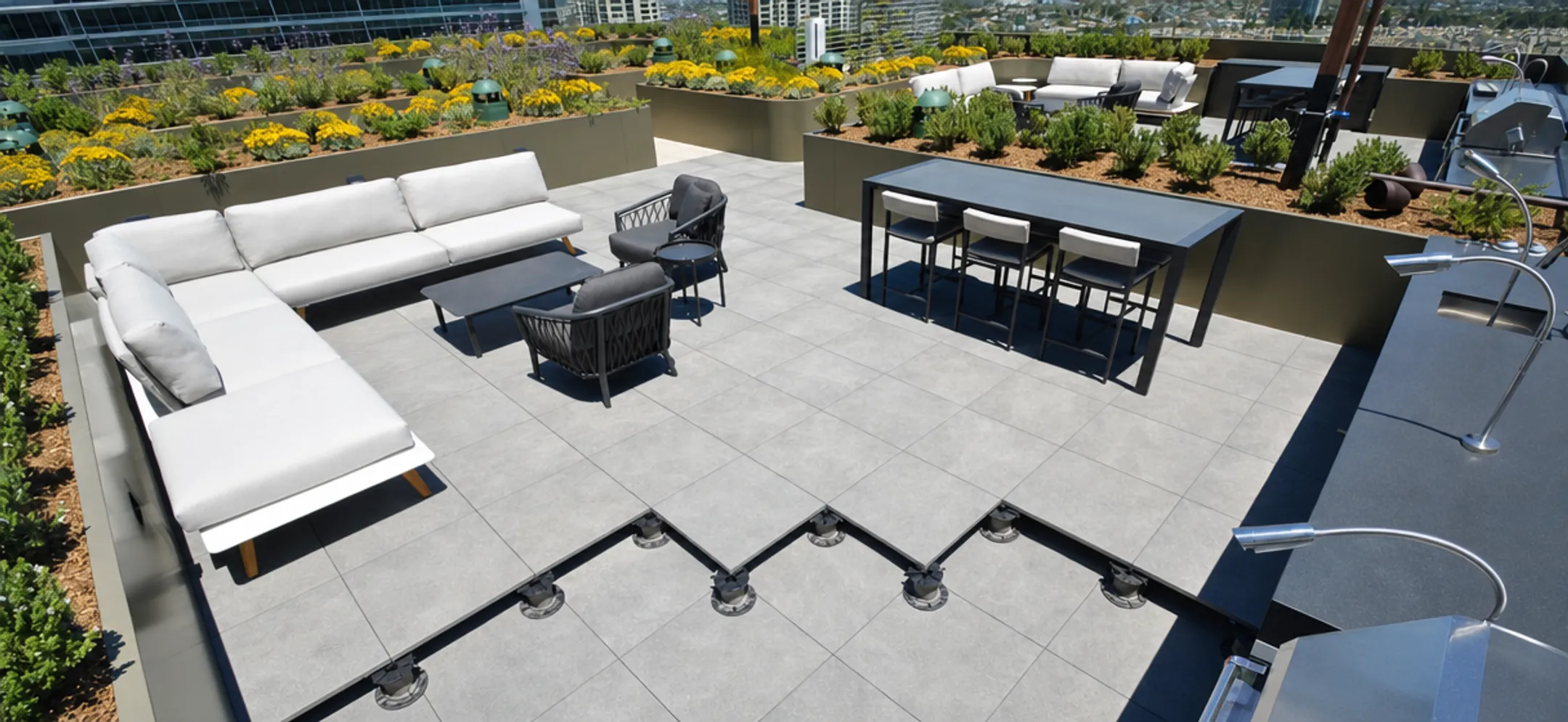Large-format porcelain pavers installed on rooftop terrace pedestal system