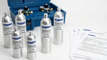 SpecGas chlorine calibration gas cylinders with NIST traceability certificates displayed