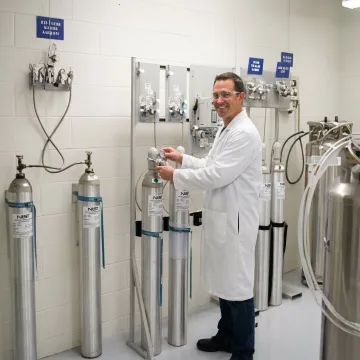 Technician preparing calibration gas cylinders
