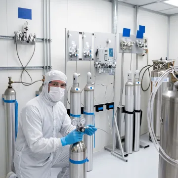 Technician preparing specialty gas cylinders for semiconductor use