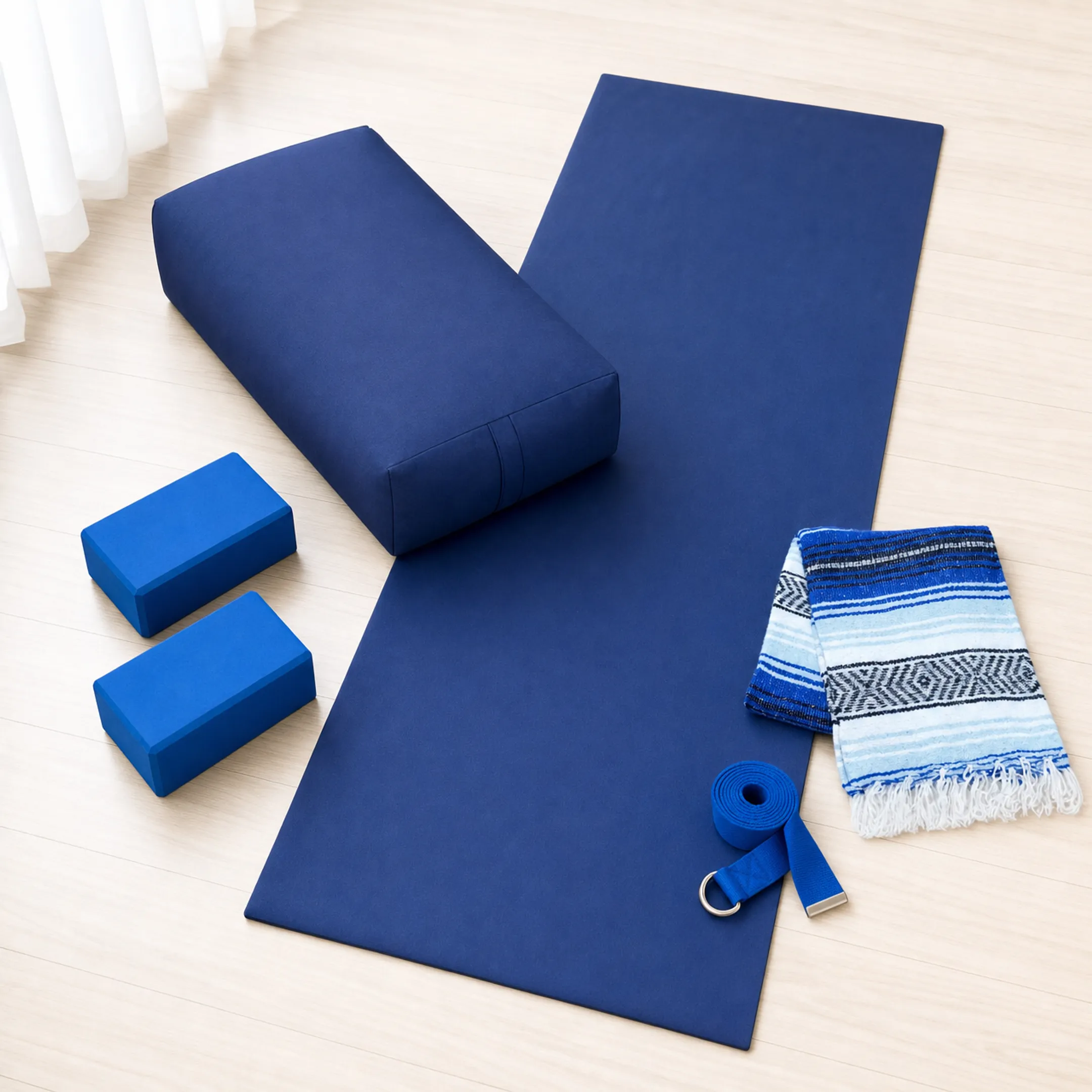 Yoga props including blocks bolster strap and blanket arranged on mat