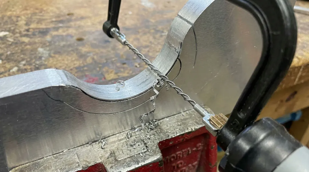 Spyral Saw 360-degree wire saw blade cutting contour on metal workpiece