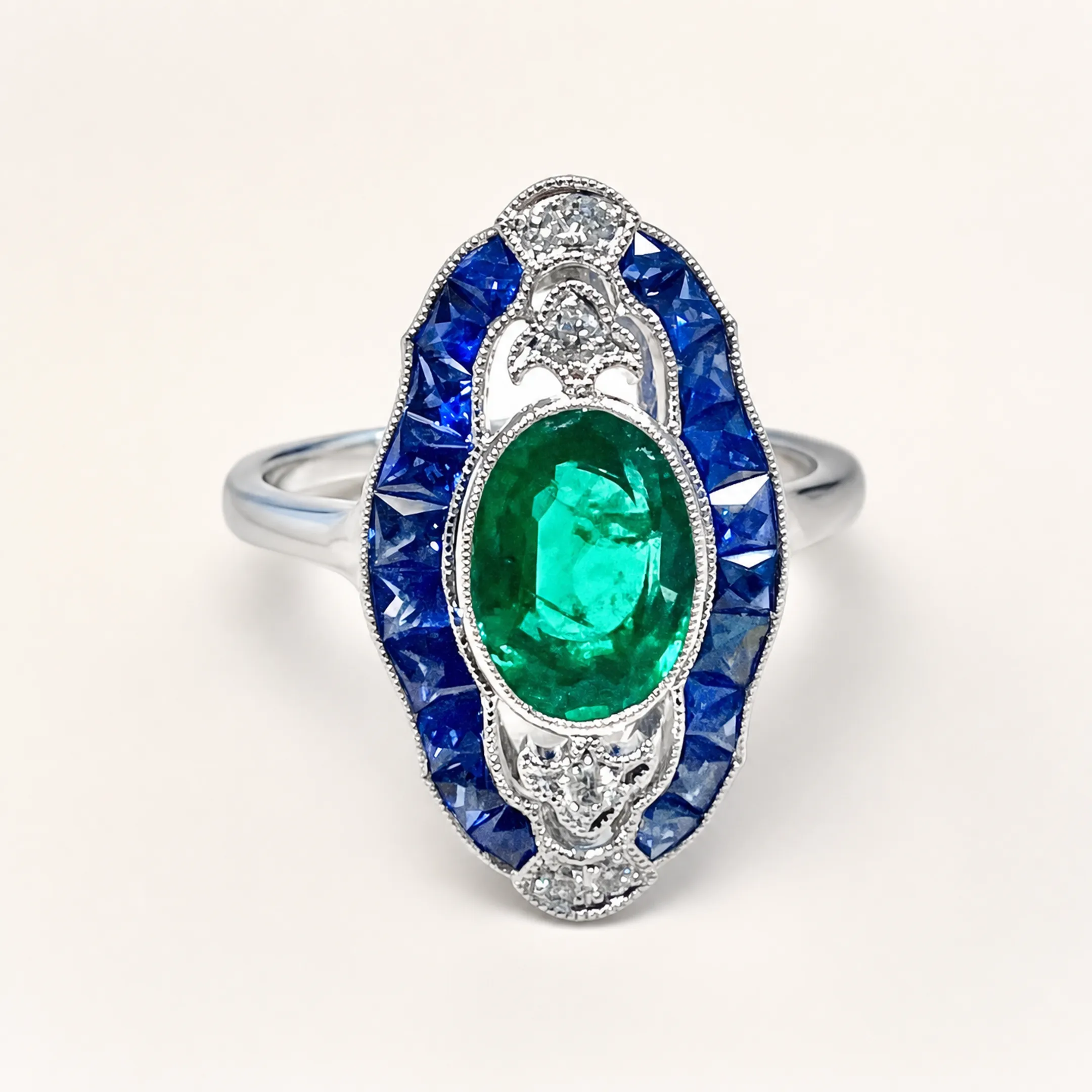 Silver and platinum jewelry with sapphire and emerald gemstones on display