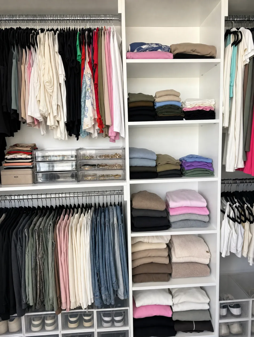 Organized walk-in closet with neatly arranged clothing and accessories