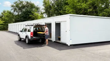 Drive-up outdoor storage units with vehicles boats and equipment loaded outside