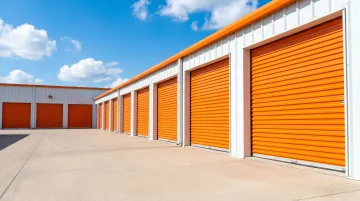 Modern self-storage facility exterior showing rows of unit doors and signage