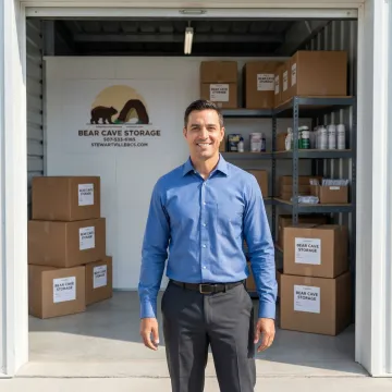 Business owner accessing commercial storage unit with inventory boxes