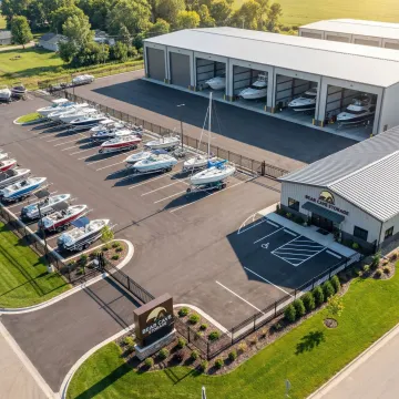 Secure boat storage facility with boats stored in covered and outdoor spaces