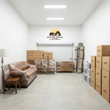 Secure storage unit interior with organized boxes and furniture