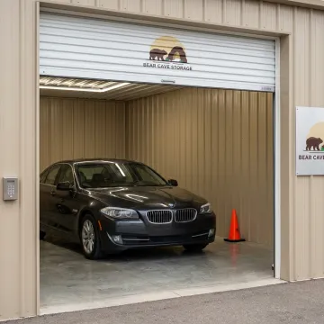 Secure indoor vehicle storage unit with car parked inside