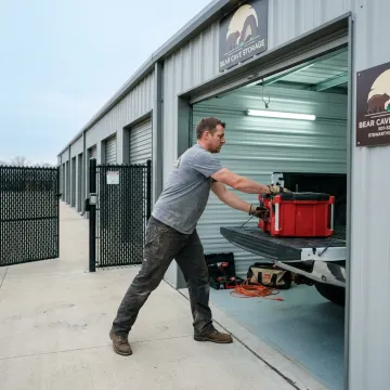 Contractor loading tools into a storage unit