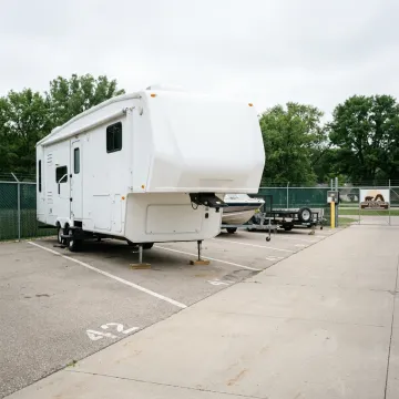Fifth-wheel RV parked at a secure storage facility