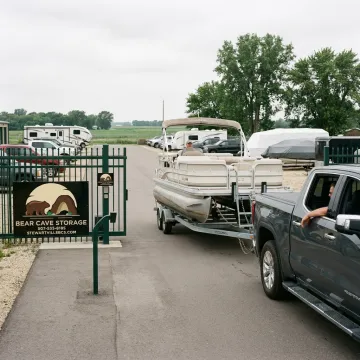 Boat trailer entering gated storage facility