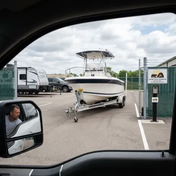 Customer parking a boat trailer in a secure storage lot