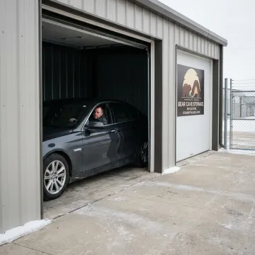 Driver moving car into enclosed storage unit