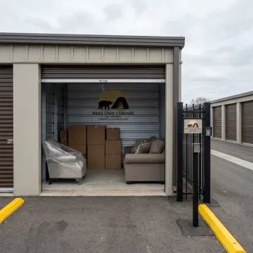 Clean drive-up storage unit with moving boxes and furniture