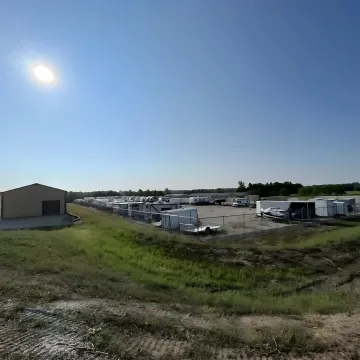 Secure RV storage facility with multiple recreational vehicles parked in protected outdoor spaces