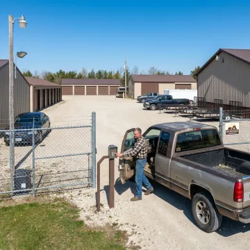 Customer accessing vehicle storage unit through gated facility