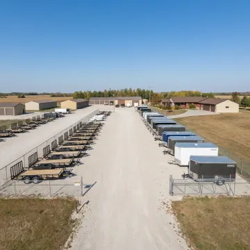 Utility trailers parked in a secure storage lot